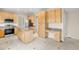Spacious kitchen featuring stainless steel appliances, granite countertops, and light wood cabinets at 5674 S Ingalls St, Littleton, CO 80123