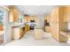 Spacious kitchen featuring stainless steel appliances and light wood cabinets at 5674 S Ingalls St, Littleton, CO 80123