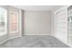 Bright living room with new gray carpet, built-in shelving and large windows at 5674 S Ingalls St, Littleton, CO 80123