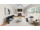 Spacious living room with a fireplace, built-in shelving, and ample seating at 5674 S Ingalls St, Littleton, CO 80123