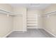 Walk-in closet featuring shelves, hanging rails, and plush carpeting at 5674 S Ingalls St, Littleton, CO 80123