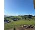 Scenic view of rolling hills and a neighborhood from the backyard of a home at 5489 Country Club Dr, Larkspur, CO 80118