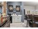 Stylish bar area with wet bar, mini fridge, and bar seating in a finished basement at 5489 Country Club Dr, Larkspur, CO 80118