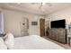 Serene bedroom with tray ceilings, wood floors, and a doorway that leads to another room at 5489 Country Club Dr, Larkspur, CO 80118