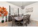 Elegant dining room with a modern chandelier, seating for eight, and an area rug at 5489 Country Club Dr, Larkspur, CO 80118