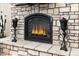 Cozy living room fireplace with stone surround and decorative accents at 5489 Country Club Dr, Larkspur, CO 80118