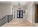 Elegant foyer with hardwood floors, an iron railing, and double doors at 5489 Country Club Dr, Larkspur, CO 80118