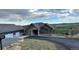 Beautiful single Gathering home with gray siding, stone accents, and a well-manicured lawn at 5489 Country Club Dr, Larkspur, CO 80118