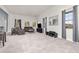 Bright living room with plush gray carpet, modern furniture, and lots of natural light at 5489 Country Club Dr, Larkspur, CO 80118