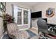 Comfortable home office featuring a large window, desk, and a relaxing chaise lounge at 5489 Country Club Dr, Larkspur, CO 80118