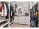 Organized walk-in closet with custom shelving, drawers, and a window for natural light at 5489 Country Club Dr, Larkspur, CO 80118