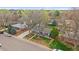 An aerial view of a charming home featuring mature trees, a detached garage, and a lovely yard at 6482 S Cedar St, Littleton, CO 80120