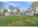Lush green backyard featuring lush green grass, a detached garage, and patio at 6482 S Cedar St, Littleton, CO 80120