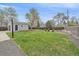 Spacious backyard featuring lush green grass and a detached garage at 6482 S Cedar St, Littleton, CO 80120