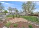 Landscaped backyard with a custom stone patio, featuring lush greenery and a charming outdoor space at 6482 S Cedar St, Littleton, CO 80120