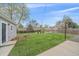 Expansive backyard featuring lush green grass, a detached garage, and privacy fencing at 6482 S Cedar St, Littleton, CO 80120