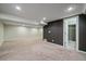 Finished basement with carpeting and view into adjacent full bathroom with tiled shower at 6482 S Cedar St, Littleton, CO 80120
