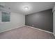 Cozy bedroom featuring neutral carpet, fresh white walls and a well-lit space through a window at 6482 S Cedar St, Littleton, CO 80120