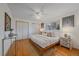 Bright bedroom with hardwood floors, white walls, ceiling fan, and double closets at 6482 S Cedar St, Littleton, CO 80120