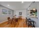 Bright dining area with hardwood floors and passthrough to kitchen at 6482 S Cedar St, Littleton, CO 80120