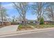 Beautiful single-story home with well-manicured lawn, brick landscaping, and inviting entrance at 6482 S Cedar St, Littleton, CO 80120