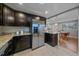 Kitchen with stainless steel refrigerator and an open view into dining area at 6482 S Cedar St, Littleton, CO 80120