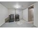 Functional laundry room with modern washer and dryer units and durable concrete flooring at 6482 S Cedar St, Littleton, CO 80120