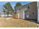 Exterior backyard showcasing a lawn, patio, and the rear of the home featuring neutral siding at 9029 W Floyd Ave, Lakewood, CO 80227