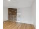 Bright loft area with wood floors, white walls, white railing, and a stone fireplace for a cozy living space at 9029 W Floyd Ave, Lakewood, CO 80227