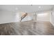 Spacious finished basement with stylish flooring and staircase, perfect for recreation or additional living space at 179 N Prairie Falcon Pkwy, Brighton, CO 80601