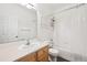 Bathroom featuring a single sink vanity and shower over tub with white tile at 179 N Prairie Falcon Pkwy, Brighton, CO 80601