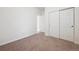 Bedroom with neutral carpet and closet with white doors, offering ample storage at 179 N Prairie Falcon Pkwy, Brighton, CO 80601