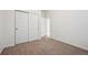 Neutral bedroom featuring carpet and a closet with sliding doors at 179 N Prairie Falcon Pkwy, Brighton, CO 80601