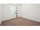 Bedroom with a window, neutral carpet, and blank canvas to make it your own at 179 N Prairie Falcon Pkwy, Brighton, CO 80601