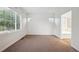 Bright bedroom with large window and neutral carpet, leading to the bathroom at 179 N Prairie Falcon Pkwy, Brighton, CO 80601