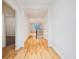Bright hallway with hardwood floors leading to the staircase and other rooms at 179 N Prairie Falcon Pkwy, Brighton, CO 80601