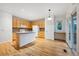 Bright eat-in kitchen showcasing a center island and stainless steel appliances at 179 N Prairie Falcon Pkwy, Brighton, CO 80601