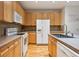 Eat-in kitchen featuring stainless steel appliances, island, and hardwood floors at 179 N Prairie Falcon Pkwy, Brighton, CO 80601