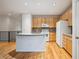Bright kitchen with maple cabinets, center island and modern appliances at 179 N Prairie Falcon Pkwy, Brighton, CO 80601