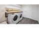 Convenient laundry room with a washer, dryer, countertop, shelves, and storage, simplifying laundry chores at 179 N Prairie Falcon Pkwy, Brighton, CO 80601