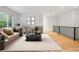 Bright living room with modern furnishings, neutral colors, and hardwood floors at 179 N Prairie Falcon Pkwy, Brighton, CO 80601