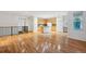 Bright open floorplan showcasing hardwood floors, kitchen, and large windows at 179 N Prairie Falcon Pkwy, Brighton, CO 80601