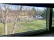 Great view from condo of grassy lawn, mature trees, and recreation area at 3161 Madison Ave # R313, Boulder, CO 80303