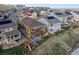 Aerial view of fenced yards, a upper wood deck, a lower patio and community at 18340 W 85Th Dr, Arvada, CO 80007