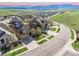 Aerial view of neighborhood homes against background of rolling hills and mountains at 18340 W 85Th Dr, Arvada, CO 80007