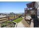 Backyard featuring an upper deck, lower patio, garden bed and wooden fence surround at 18340 W 85Th Dr, Arvada, CO 80007