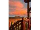 Balcony view capturing a warm, colorful sky and the silhouettes of nearby homes at 18340 W 85Th Dr, Arvada, CO 80007