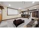 Finished basement featuring a large projector screen, bar, and comfortable seating area at 18340 W 85Th Dr, Arvada, CO 80007