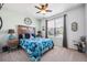 Serene bedroom with a ceiling fan, soft carpet, and a comfortable bed with stylish bedding at 18340 W 85Th Dr, Arvada, CO 80007