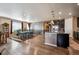 Open-concept dining area with hardwood floors and ample natural light adjacent to the modern kitchen at 18340 W 85Th Dr, Arvada, CO 80007